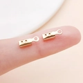 Golden DIY leather cord end crimp fastener with ring loop held on fingers for scale - KC Gold Large Style with Points