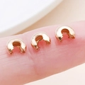 Rose gold moon crescent crimp covers shown on fingertip for scale reference - KC Gold - Medium