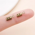 Pair of rectangular antique bronze end caps for jewelry cords shown on a finger for scale - Antique Bronze Large Style with Points