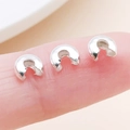 Silver-plated C-shaped crescent bead caps shown on fingertip for DIY jewelry size scale - Silver - Medium