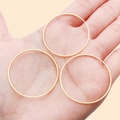Three golden round copper rings held in hand as DIY jewelry accessories components - 35mm / Gold