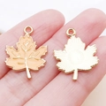 Golden and orange enamel maple leaf charm for DIY jewelry making shown on hand - 22x16mm / Yellow Thanksgiving Maple Leaf (19210)