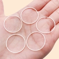 Set of five silver geometric round rings displayed on a palm for DIY jewelry making - 25mm / Bright Silver