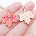 Orange maple leaf charm with red bow detail and golden textured back for DIY jewelry - 25x20MM / Orange Bow Maple Leaf (25234)