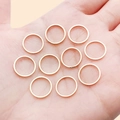 Set of 10 rose gold minimalist geometric rings displayed in hand for DIY jewelry - 12mm / KC Gold