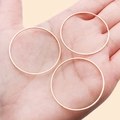 Three minimalist rose gold geometric round rings shown on a hand for scale - 35mm / KC Gold
