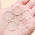 Set of five minimalist rose gold geometric thin rings displayed on a hand palm - 20mm / White Gold