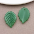 DIY jewelry parts featuring two green resin leaf pendants with detailed leaf veins - Jelly Dark Green Tea Strawberry Leaf (26904) / 24x17mm
