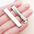 Silver rectangle metal hair clips for DIY crafts shown on palm for scale reference - 41x10mm / White Gold