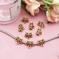 Detailed view of antique gold bale beads with engraved texture on a snake chain - Vintage Circle Barrel Style (14330)