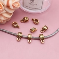 Macro detail of antique gold bail beads with vintage floral textures for DIY jewelry - Embossed Floral Cylinder Style (14340)