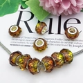 Macro shot of amber gradient faceted glass beads with silver cores on a snake chain - Faceted Bead (16294) / 1 Piece / Brown Yellow Gradient