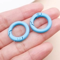 Two pieces of light blue 25mm matte finish zinc alloy round spring rings held in a hand - Thick 20mm Inner Diameter 13mm / Blue