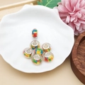 Detail showing colorful geometric acrylic beads with metal core in a decorative shell dish - Rainbow Faceted Colorful Style (14440) / 1 Piece (9x13mm)