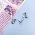 Pair of vintage silver saxophone alloy charms for DIY jewelry making on soft background - Saxophone Style 2