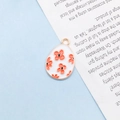 Oval enamel rabbit egg pendant in white with orange floral pattern and gold plating - Red Flower Egg