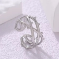 Macro shot of silver titanium steel X-shaped ring with textured beads and open design - Beaded Multi-Layer Style (40348-2)