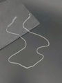 Detail of silver stainless steel box chain with lobster clasp and adjustable link on stone - Silver