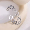 Macro detail of silver adjustable ring featuring a hollow heart pattern design - Hollow Heart / Silver