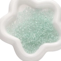 Translucent mint green glass beads for DIY jewelry making in a white ceramic dish - 450g Pack (2x4mm, Approx. 6700 Pieces) / Light Green