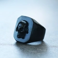 Macro shot of punk style black titanium steel ring with 3D skull relief for men - US 7 / Black