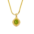 Macro view of vintage gold snake chain with an oval green gemstone pendant detail - Gold Green Cat Eye Stone