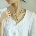 Vintage style gold necklace with oval turquoise stone pendant and lace detail - Gold Lake Blue Cat Eye Stone