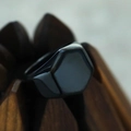 Macro shot of minimalist hexagonal black matte titanium steel signet ring for men - US 9 / Black