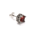 Macro view of vintage silver stud earring with a round red stone and distressed texture - Steel Red Zircon