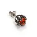 Macro shot of vintage titanium steel stud earring with orange zircon and hollow carvings - Steel Color Orange-Red Rhinestone