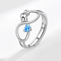 Adjustable silver spinner ring with infinity design and triangular blue zircon stone - Open Adjustable / March (Light Blue)