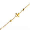 Macro shot of gold-plated clover bracelet with zircon petals and small golden beads - Gold Yellow Zirconia