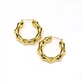 Macro detail of large gold bamboo-shaped hoop earrings with polished titanium steel texture - Gold Bamboo Style