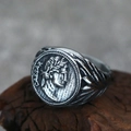 Macro shot of retro Roman Caesar portrait ring with engraved wheat pattern on wood - US 7 / Steel