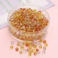Mix of warm amber and yellow 4mm glass seed beads in a round transparent box for DIY jewelry - Yellow Silver Series