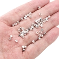 Faceted silver alloy spacer beads for jewelry making held in hand for size scale - Hexagon Beads 3x3mm (Aperture 1.5mm) / Silver (Approx. 25 Pieces/Pack)