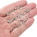 Polished silver faceted spacer beads for DIY jewelry making shown in hand - Small Square Beads 2mm (Aperture 1mm) / Silver (Approx. 25 Pieces/Pack)