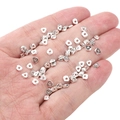 Polygonal silver spacer beads for DIY jewelry making held in hand for scale - Small Faceted Triangle 1x4mm (Aperture 1mm) / Silver (Approx. 25 Pieces/Pack)