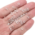 Silver metal jump rings for jewelry making held in palm to show small scale - Spiral Loop 4mm (Aperture 1.5mm) / Silver (Approx. 25 Pieces/Pack)