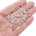 Silver metal faceted spacer beads for DIY jewelry making held in a hand for scale - Curved Pattern Round 4mm (Aperture 1mm) / Silver (Approx. 25 Pieces/Pack)