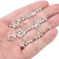 Silver hollow spacer beads with geometric engravings displayed on palm for scale - Polka Dot Checkered 4mm (Aperture 1mm) / Silver (Approx. 25 Pieces/Pack)