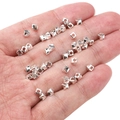 Silver twisted cube spacer beads for DIY jewelry held in hand on white background - Twisted Grain 3x4mm (Aperture 1.5mm) / Silver (Approx. 25 Pieces/Pack)