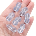 Peanut-shaped light blue glass bead for DIY jewelry making held in a hand - 12x23mm (Aperture 1mm) / Blue