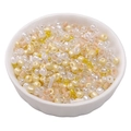 Colorful mixed glass seed beads in a white bowl for DIY jewelry making and crafts - Sun Orange