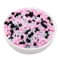 Mixed pink and black glass seed beads in a white bowl for DIY bracelet making - Black Pink Mix