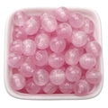 Perles roses scintillantes en résine pour bijoux DIY dans un petit bol décoratif - Rose