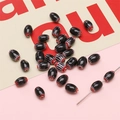 Perles millefiori ovales noires avec motifs étoiles rouges et blanches pour bijoux DIY - 10 Pièces/Paquet (6x9mm, Trou 1mm) / Noir