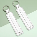 Set of two white leather strap keychains with silver rings and rivet details - Silver