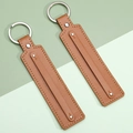 Brown leather keychain set with fine stitching and silver metal ring fasteners - Tan