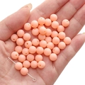 Matte apricot pink acrylic beads for DIY jewelry making shown in hand for scale - Creamy Green